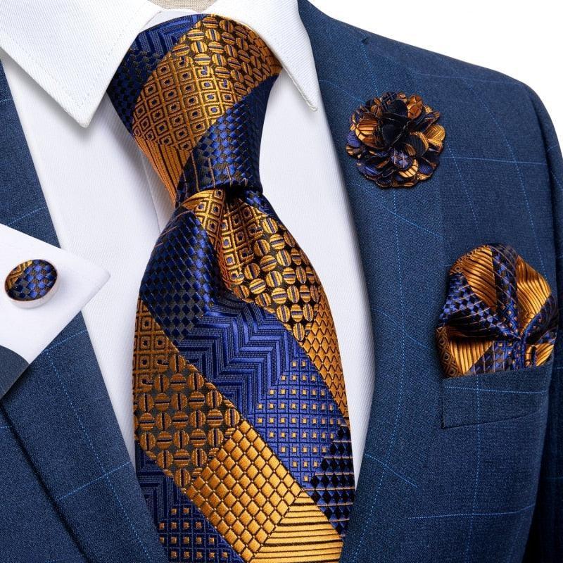 Luxury blue and gold patterned necktie set with matching pocket square, boutonniere, and cufflink on blue suit, GUOCALI Paris men's fashion accessories