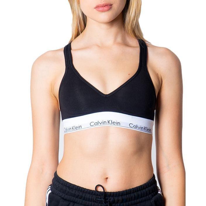 Woman in black Calvin Klein bralette and black pants, luxury women's underwear at GUOCALI