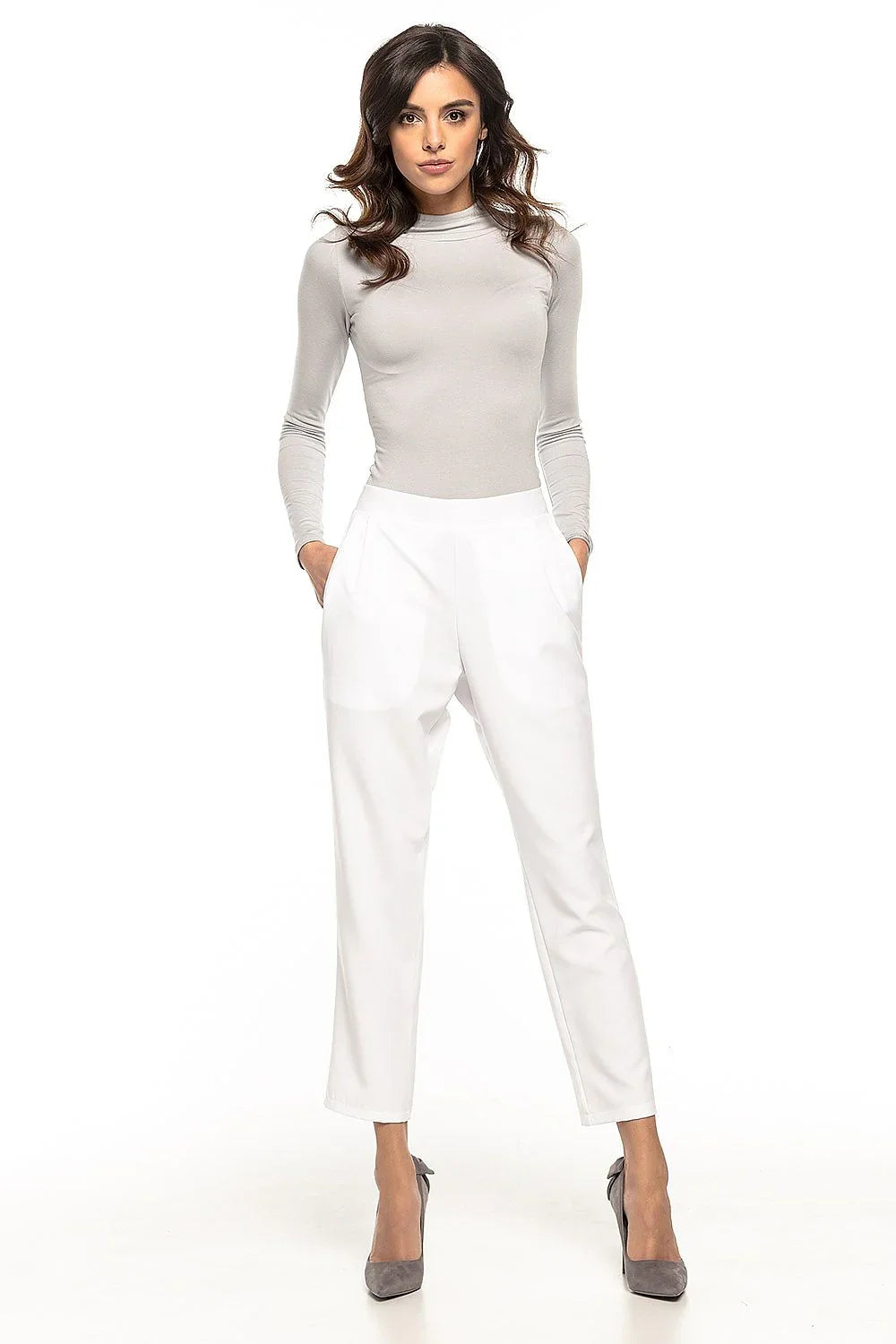 Woman in white cropped tapered trousers with a grey top and grey heels fashion image